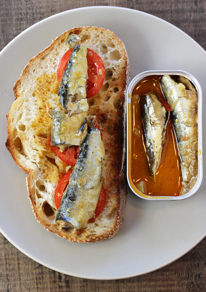 Grilled bread with summer tomatoes and new Patagonia Provisions Sardines in Coconut Curry.